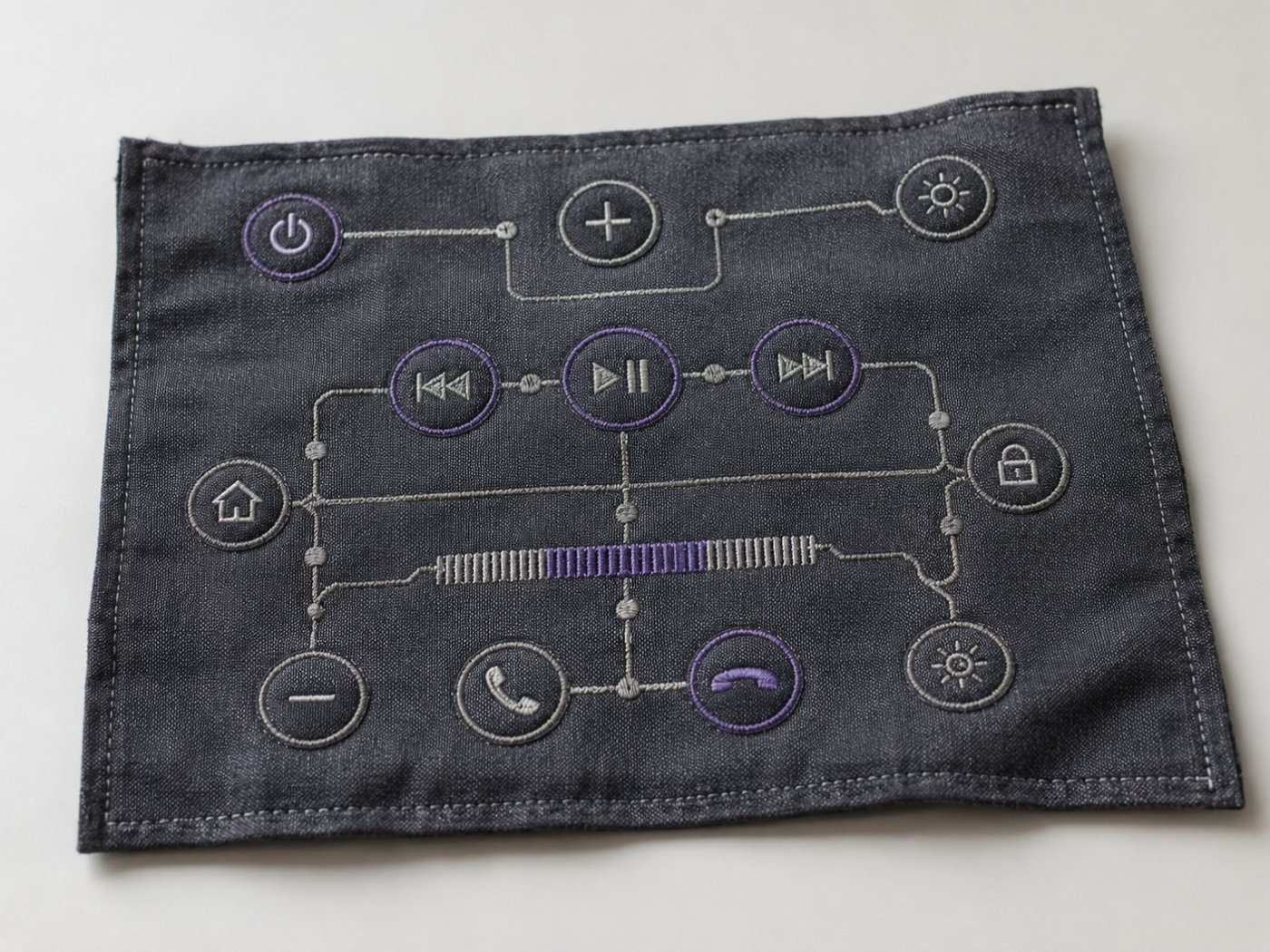 Embroidered media-control touchpad patch