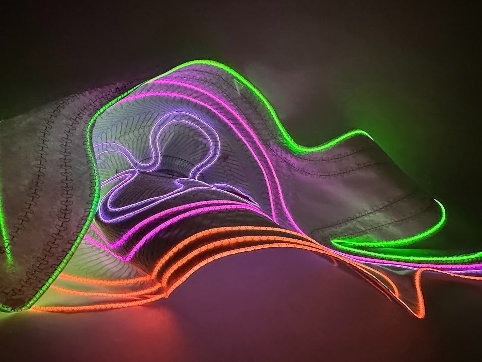 Glowing EL wire stitched into a flexible textile