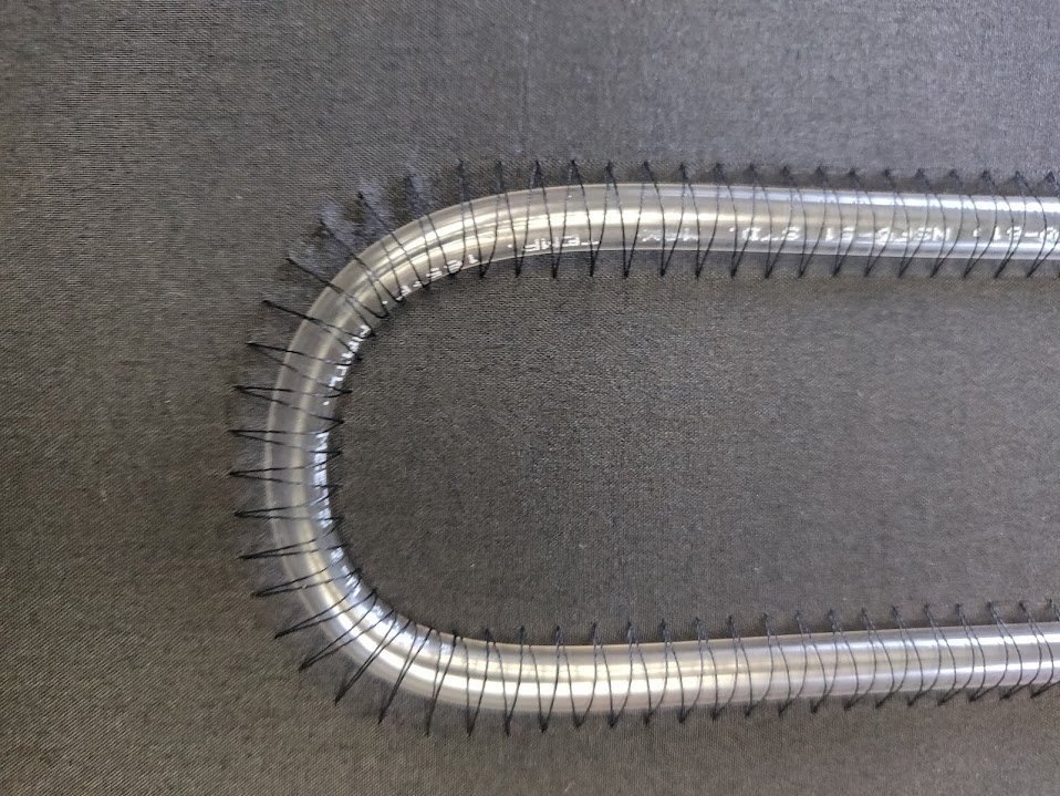Clear silicone tube couched in a serpentine route